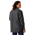 Man wearing a black and white patterned shirt on a white background