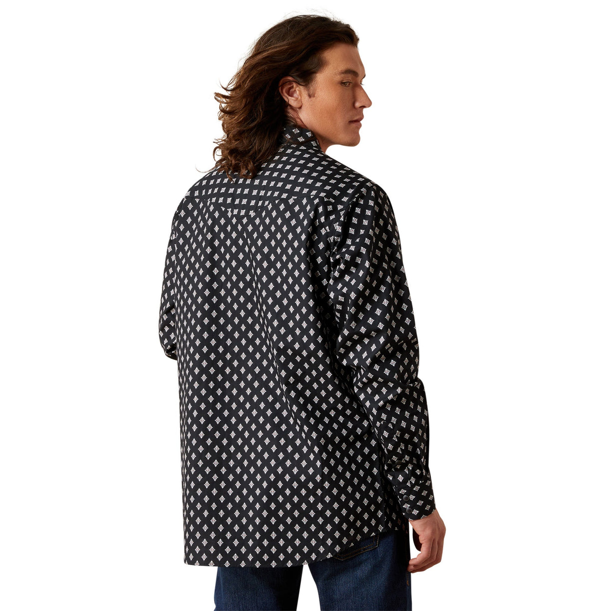 Man wearing a black and white patterned shirt on a white background