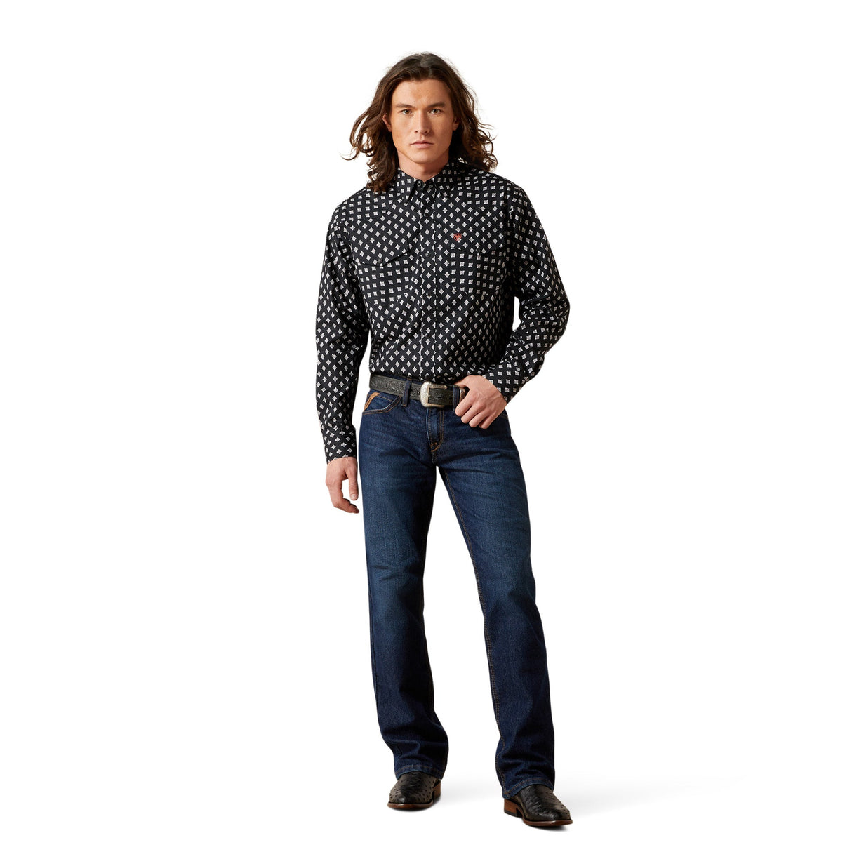 Man wearing a black patterned shirt and blue jeans on a white background