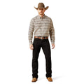 Man wearing a patterned shirt, black pants, and a cowboy hat on a white background