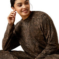 Woman wearing a brown patterned outfit on a white background