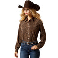 Woman wearing a brown patterned shirt, blue jeans, and a brown cowboy hat on a white background