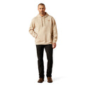 Man wearing a beige hoodie and black pants on a white background