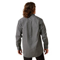 Person wearing a long-sleeve patterned shirt on a white background