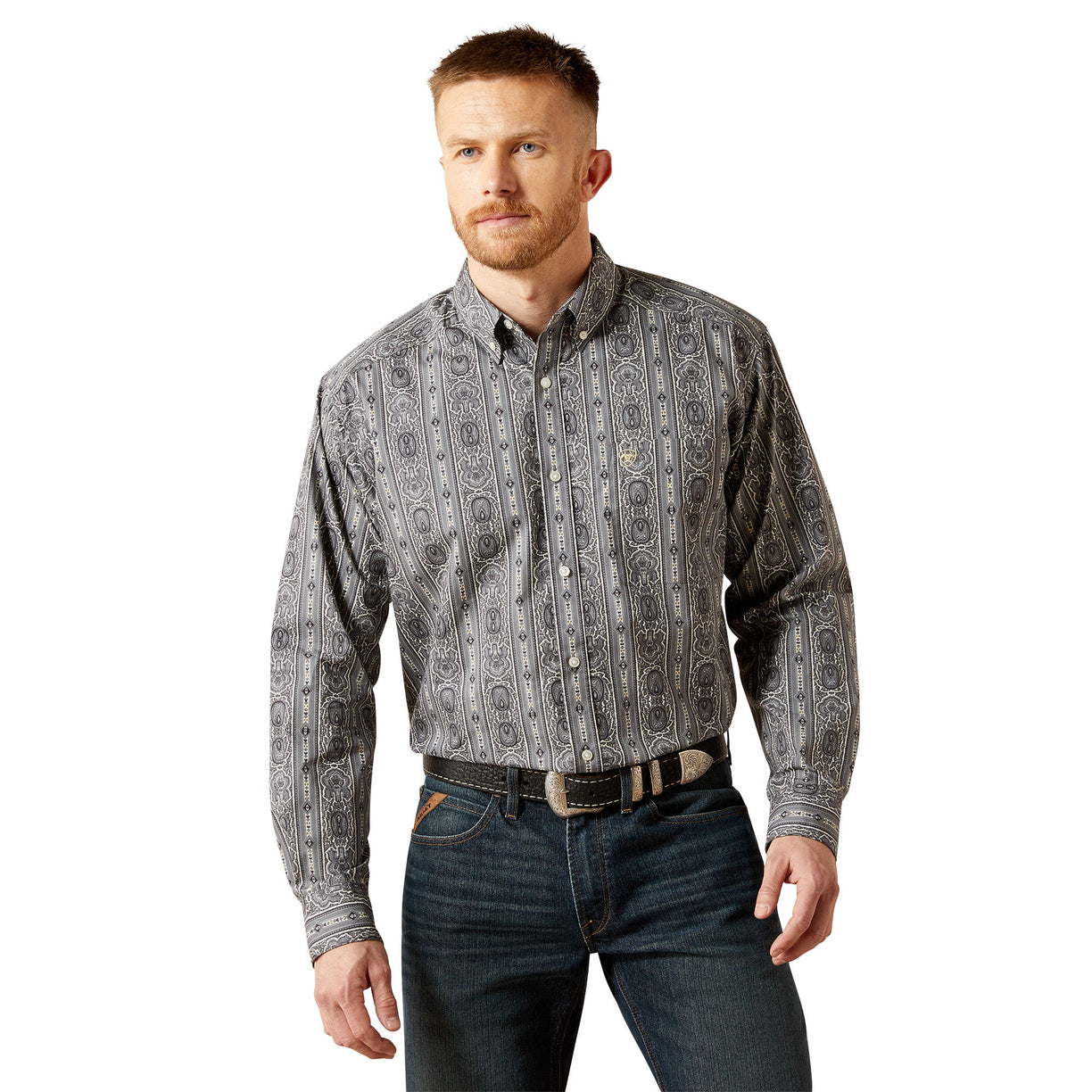 Man wearing a patterned shirt and jeans on a white background