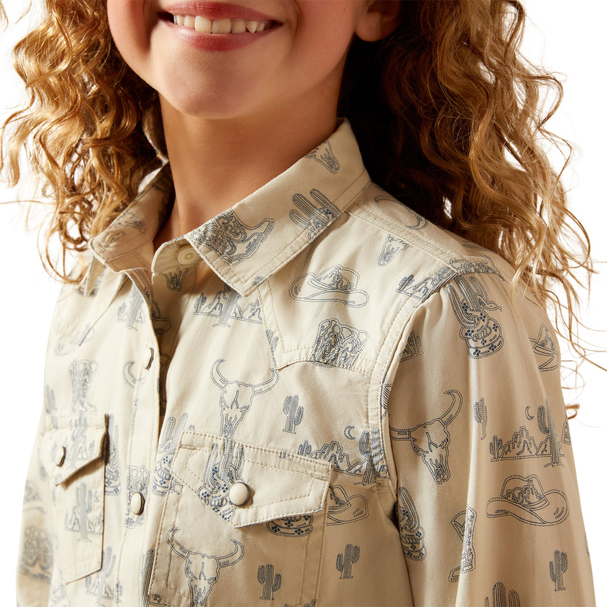 Close-up of a person wearing a beige shirt with western-themed pattern on a white background