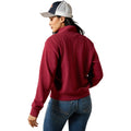 Person wearing a red sweater and blue jeans on a white background
