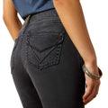 Person wearing black jeans with a white background