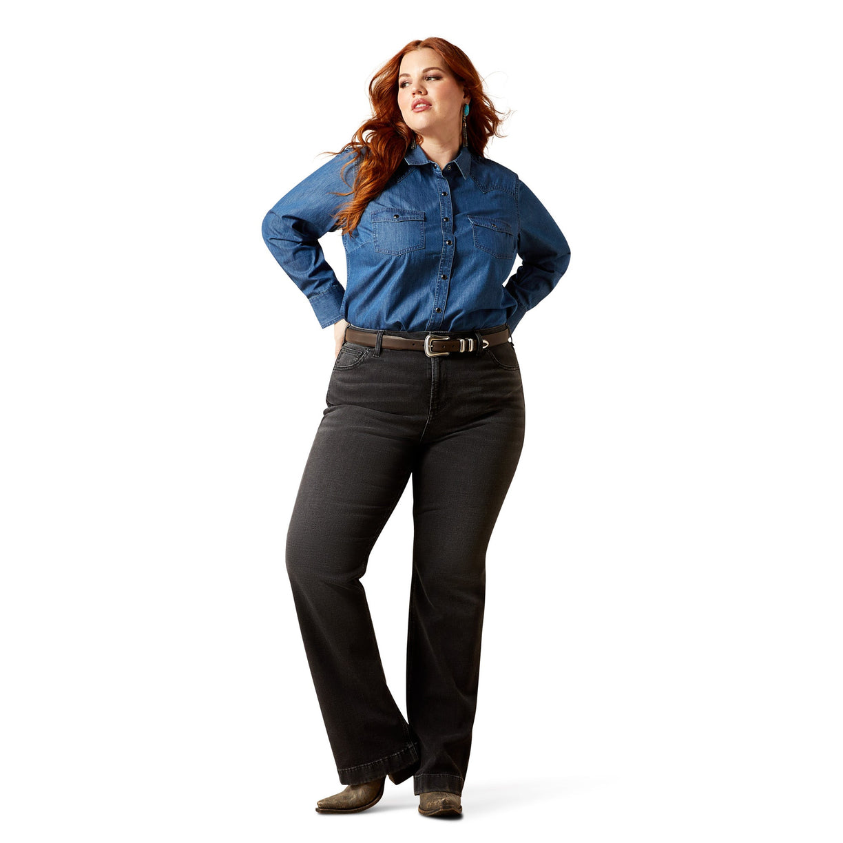 Woman wearing a blue denim shirt and black pants on a white background