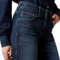 Close-up of blue jeans with a brand logo on a white background