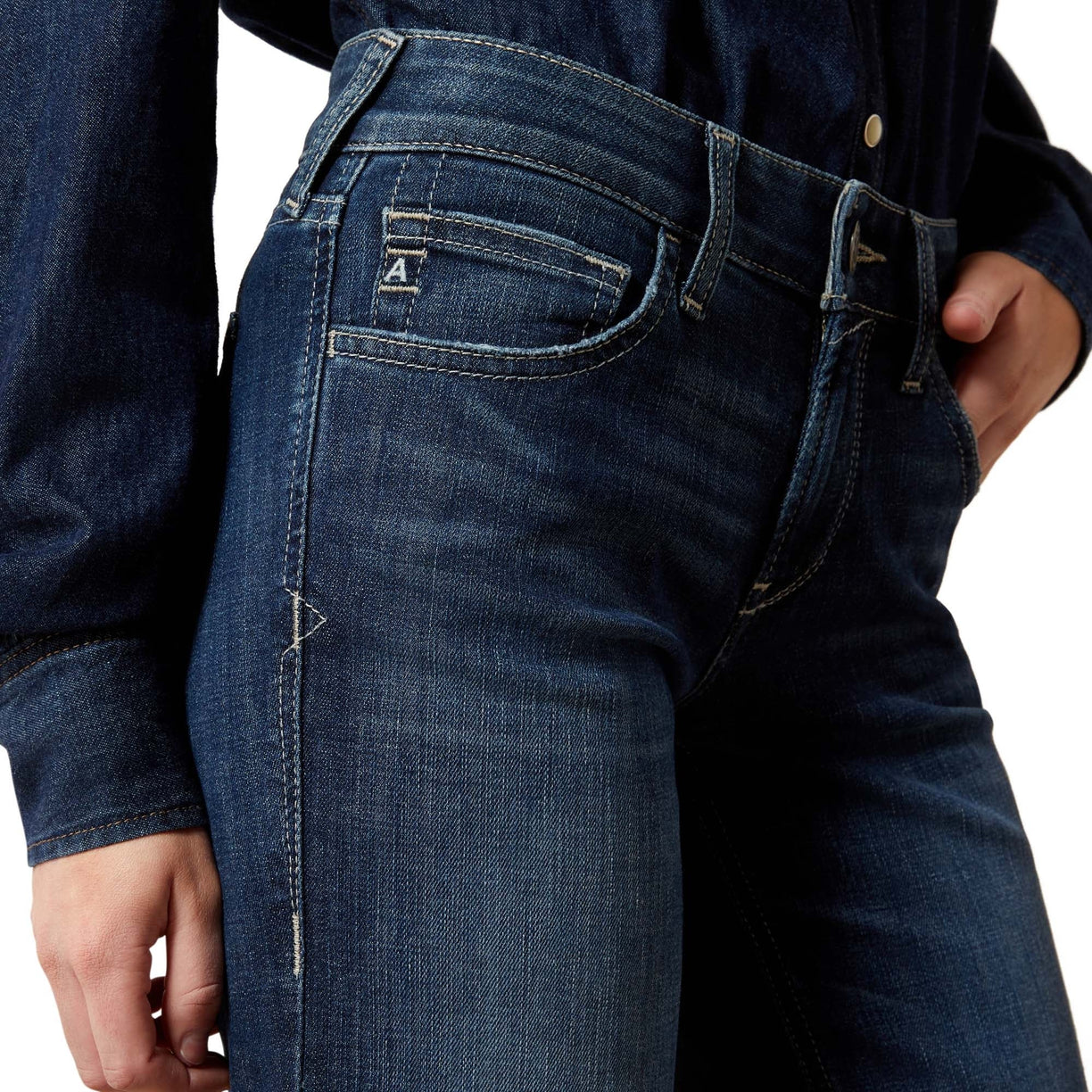 Close-up of blue jeans with a brand logo on a white background