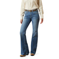 Person wearing blue jeans and a beige shirt on a white background
