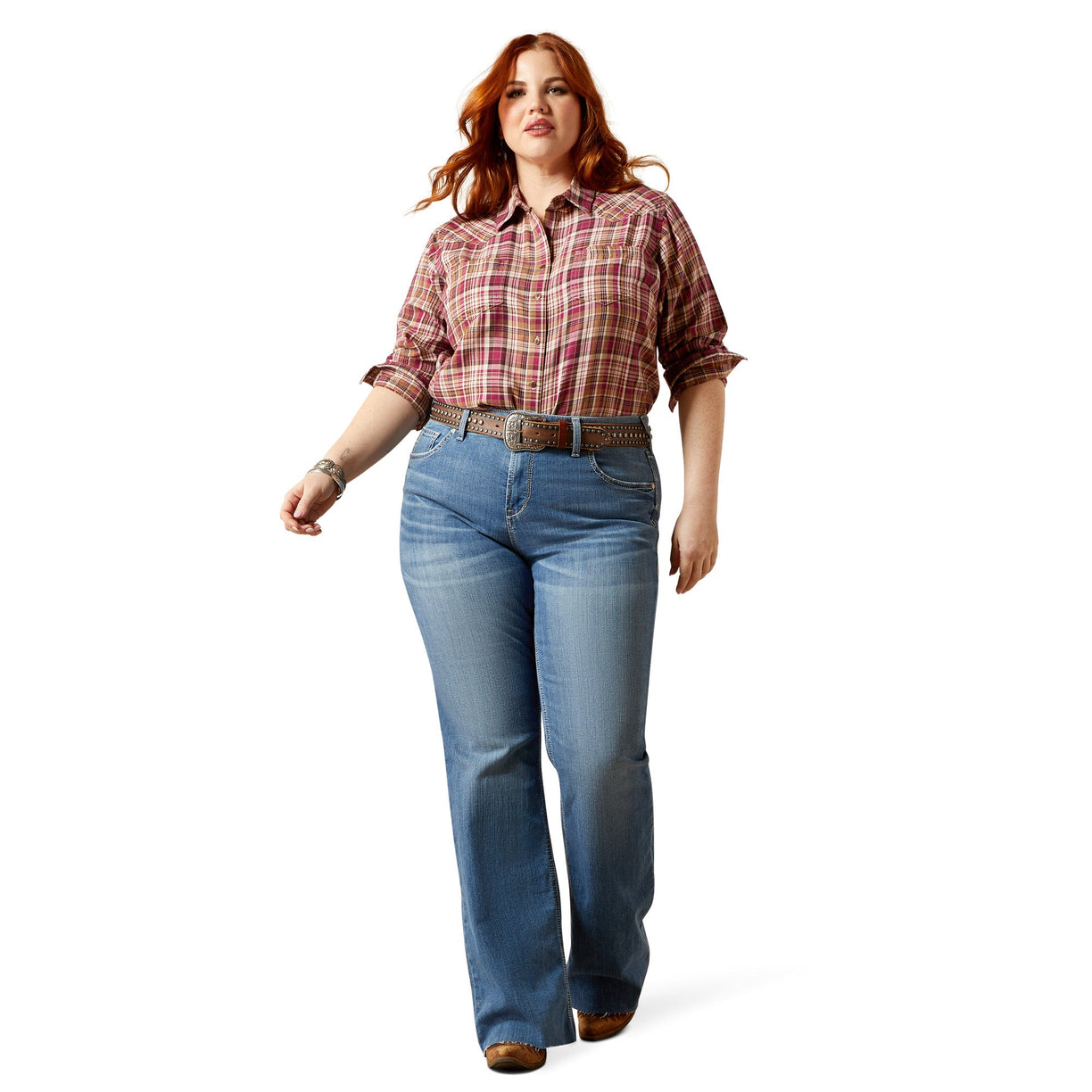 Woman wearing a plaid shirt and blue jeans on a white background