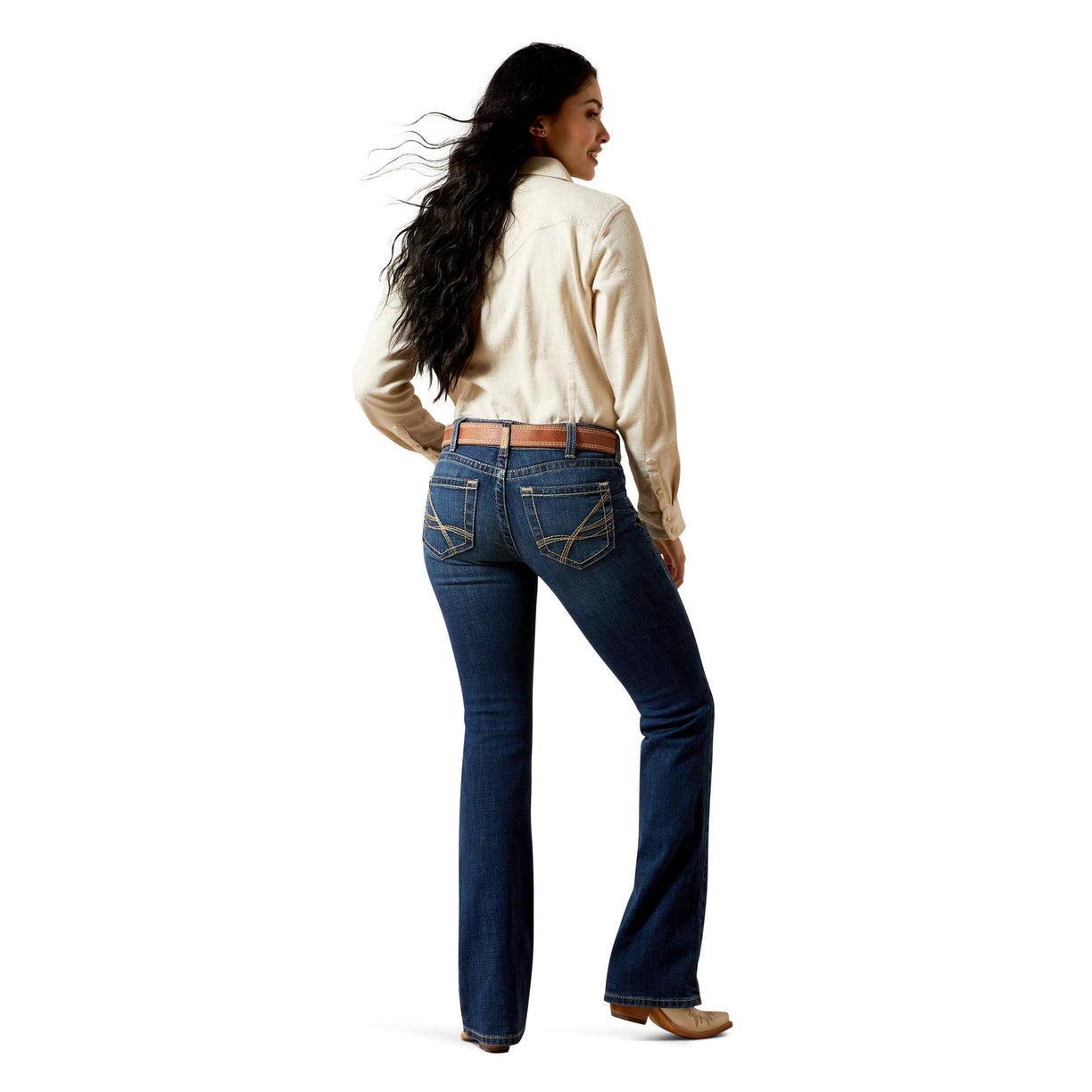 Woman wearing blue long leg  denim jeans belt loops and a cream shirt on a white background
