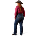 Person wearing a red shirt, blue jeans, and a cowboy hat on a white background