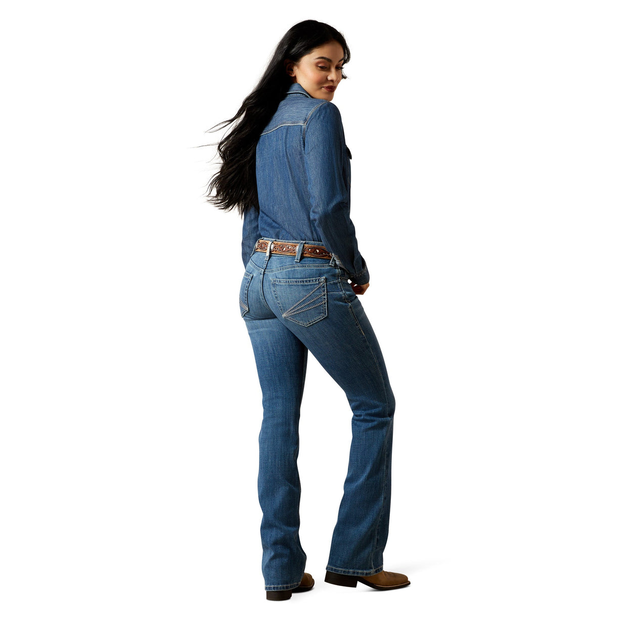 Woman wearing a blue denim outfit on a white background