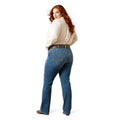 Plus size woman wearing blue jeans and a white shirt on a white background