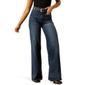 Person wearing blue jeans on a white background