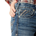 Close-up of blue jeans with a brand logo on a white background