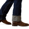 Brown leather boots with rolled-up jeans on a white background