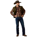 Man wearing a cowboy hat, plaid shirt, vest, and jeans on a white background