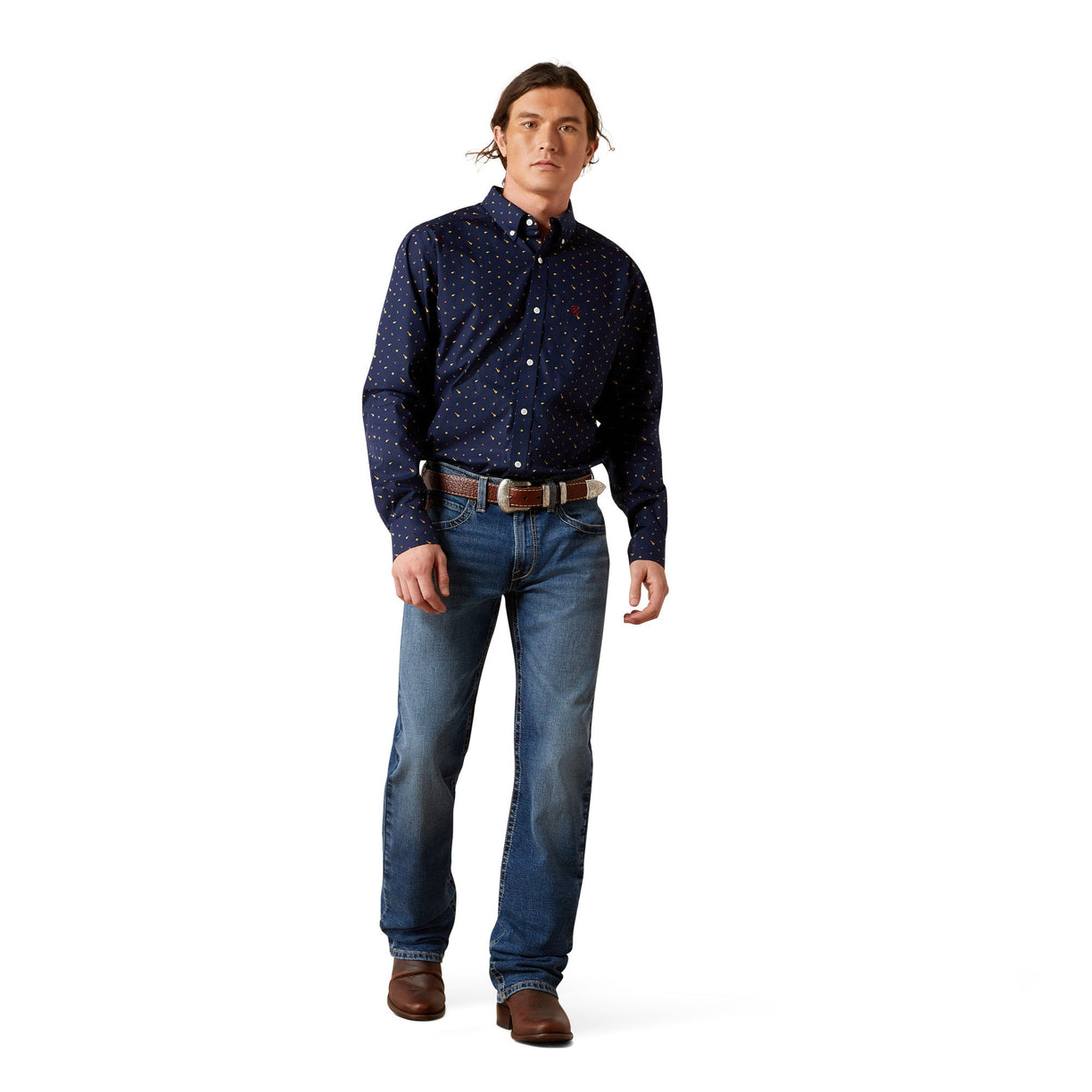 Man wearing a dark blue patterned shirt and jeans on a white background