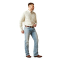 Man wearing a light-colored shirt and blue jeans on a white background