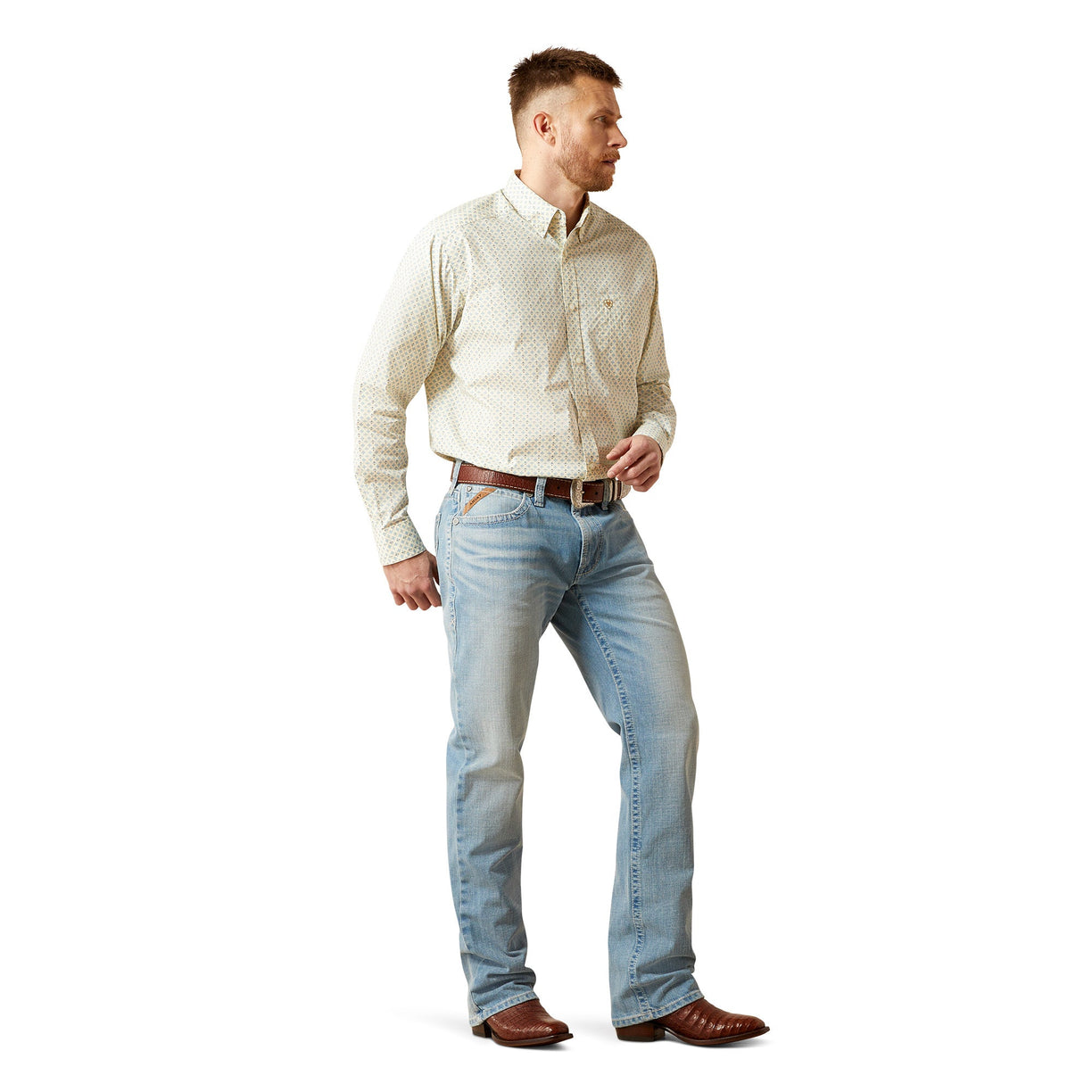Man wearing a light-colored shirt and blue jeans on a white background