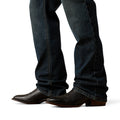 Dark blue jeans and brown boots on a white background