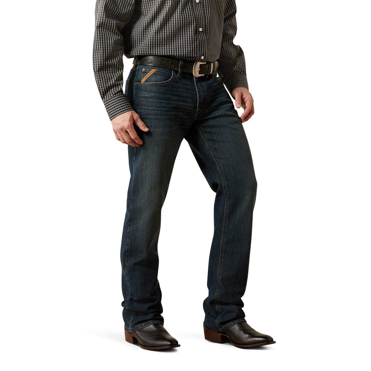 Person wearing dark blue jeans and a checkered shirt on a white background