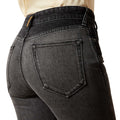 Black jeans with a focus on the back pocket on a white background