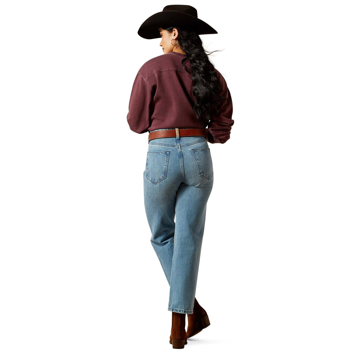 Person wearing a maroon shirt, blue jeans, and a cowboy hat on a white background