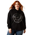 Woman wearing a black hoodie with Ariat logo on a white background