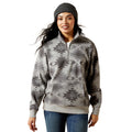 Woman wearing a gray patterned pullover with a white background
