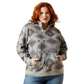 Woman wearing a gray patterned pullover with a white background