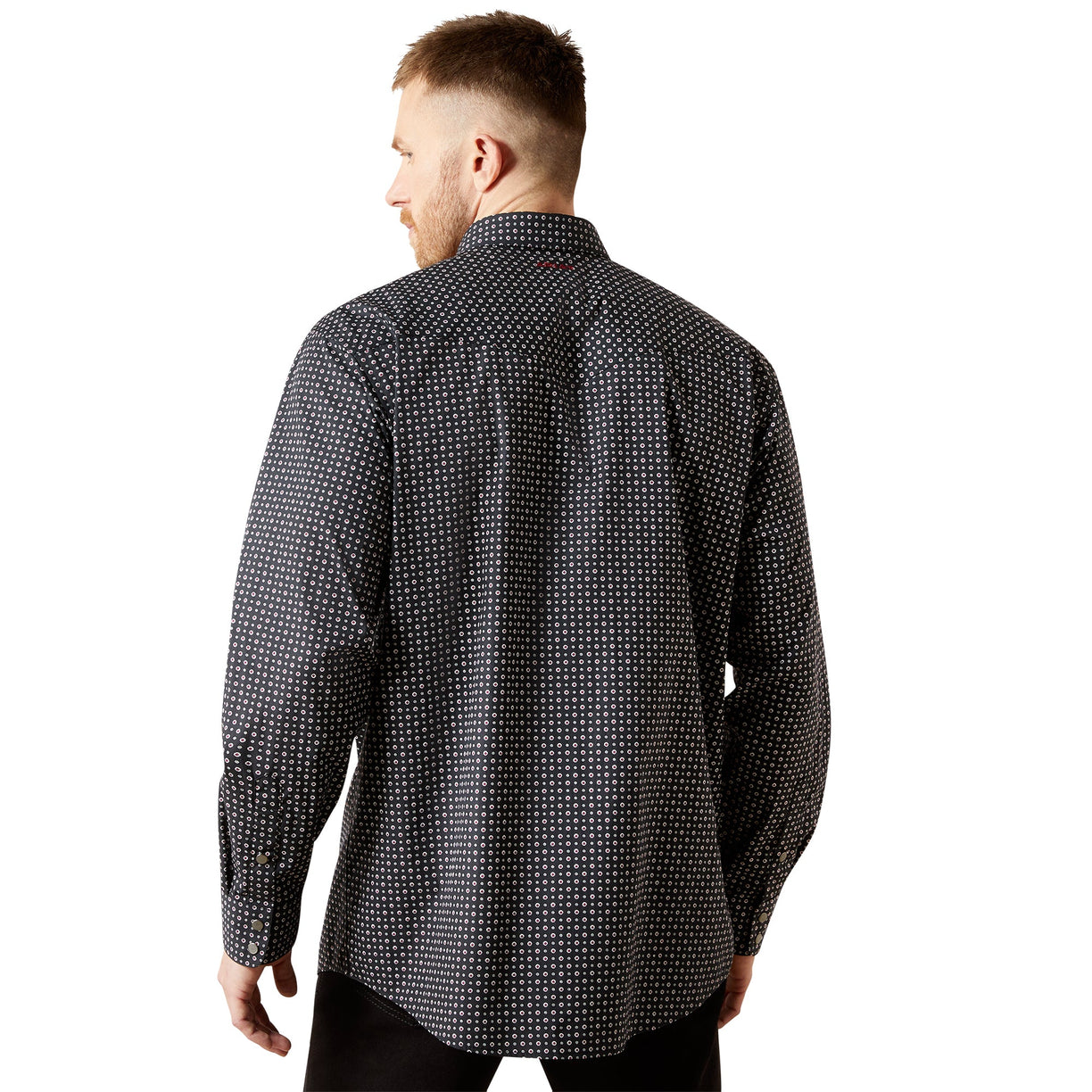 Man wearing a black patterned shirt on a white background