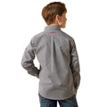 Child wearing a patterned shirt on a white background
