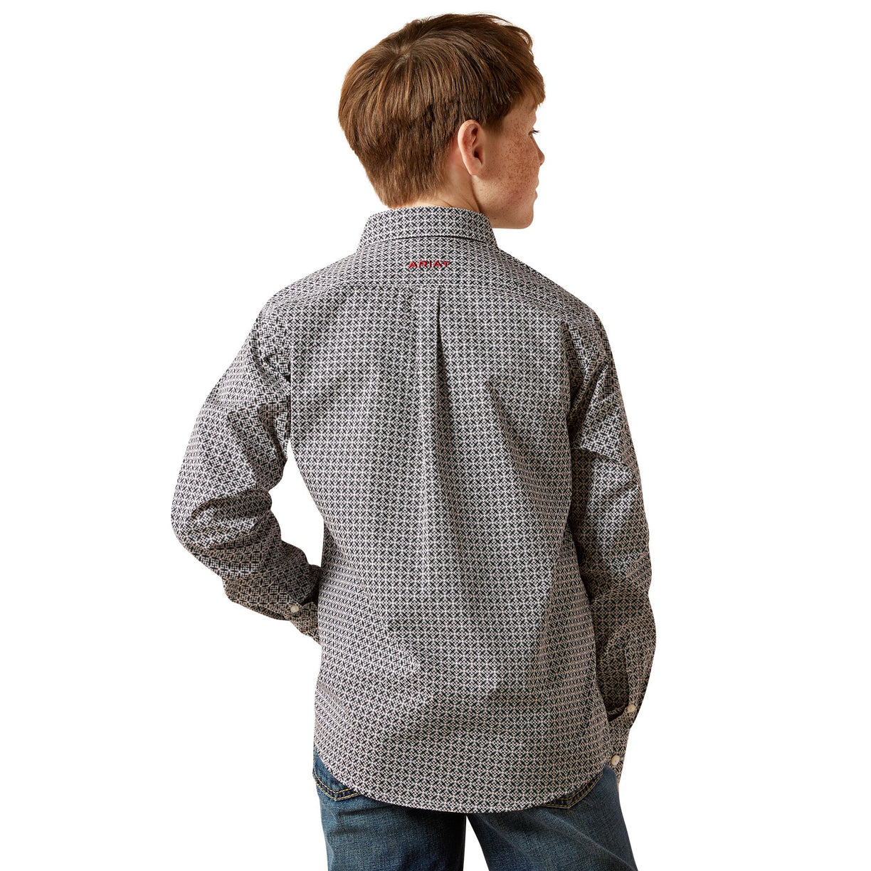 Child wearing a patterned shirt on a white background