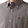Close-up of a patterned shirt with a red logo on the chest.
