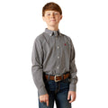 Young boy wearing a patterned shirt and jeans on a white background