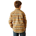 Person wearing a patterned shirt with a beige background
