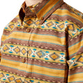 Close-up of a patterned shirt with geometric designs in yellow, brown, and blue.