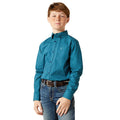 Young boy wearing a teal patterned shirt and jeans on a white background