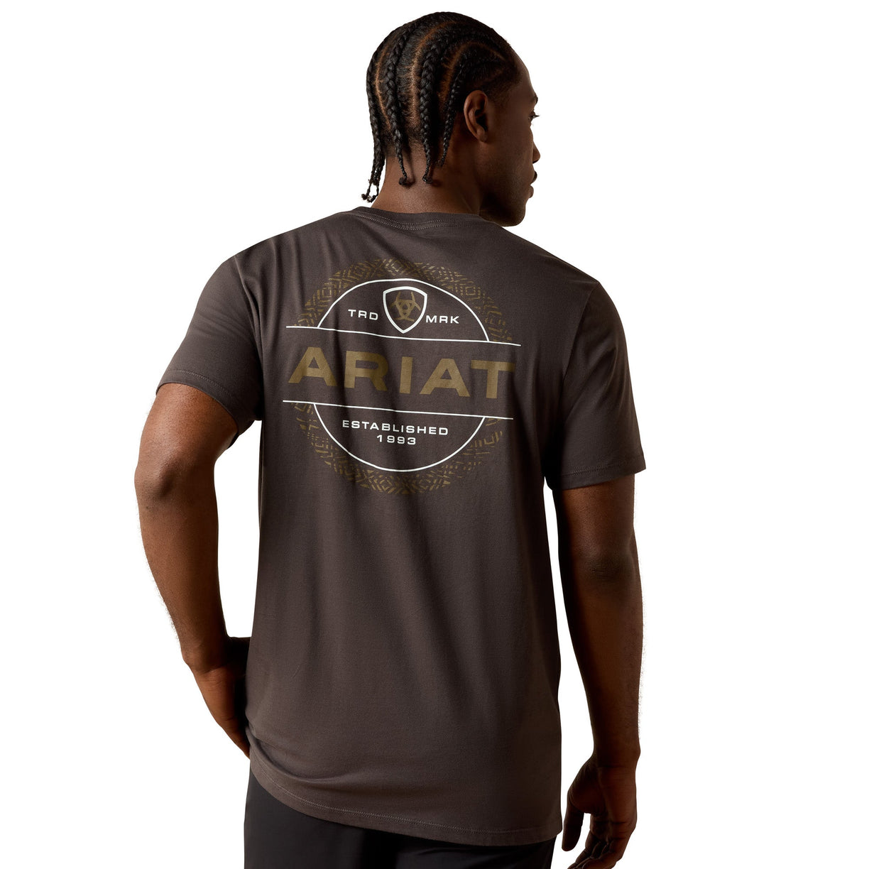 Man wearing a brown Ariat t-shirt with branding on the back against a white background