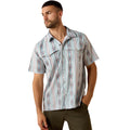 Pale blue striped ikat print short-sleeve western snap shirt with pointed western yoke, worn with olive pants.