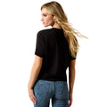 Woman wearing a black t-shirt and blue jeans on a white background