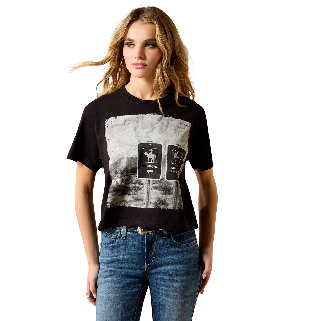 Woman wearing a black t-shirt with graphic design and blue jeans on a white background