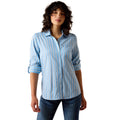 Woman wearing a light blue striped shirt and jeans on a white background