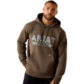 Man wearing a brown hoodie with 'Ariat Work' text on a white background
