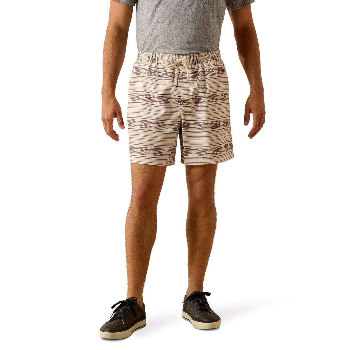 Person wearing patterned shorts on a white background